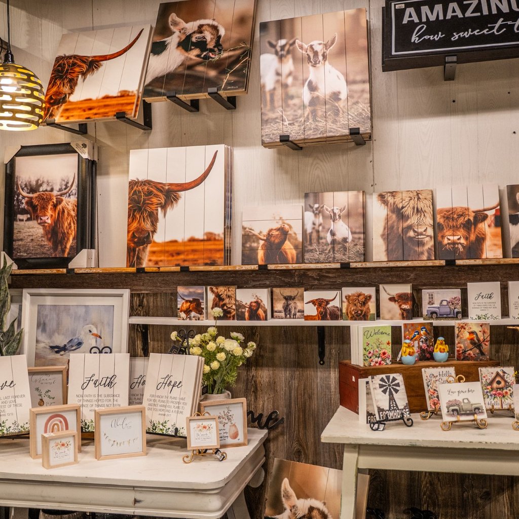 Home decor vendor booth with wall art and accents inside Ohio's Market Berlin in Berlin, OH