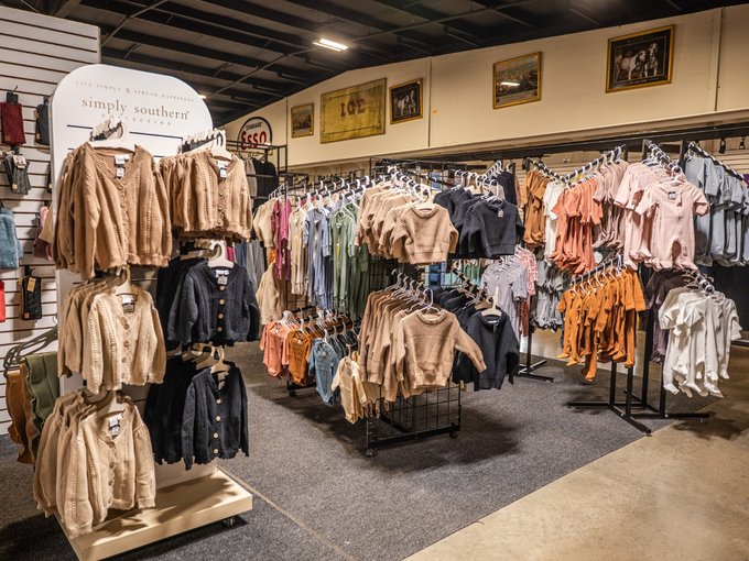 Parents browsing children's outfits in person at Ohio's Market Berlin in Berlin, OH
