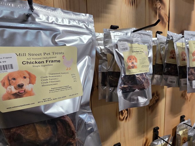Hand-picked pet treats and leashes on a vendor shelf at Ohio's Market Berlin in Berlin, OH